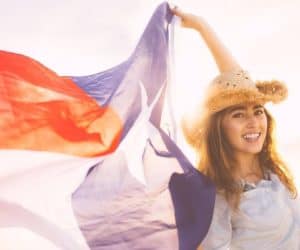 woman holding a texas flag, happy because of the solar incentives for the dallas-fort worth metro area