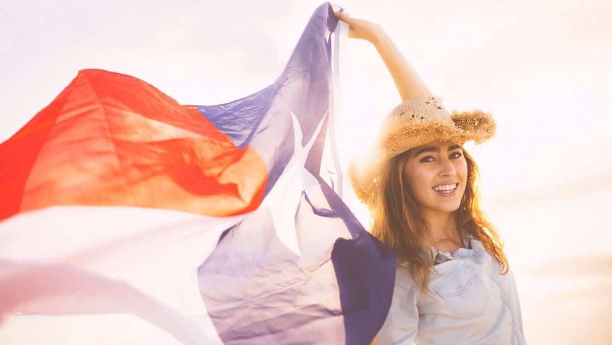 woman holding a texas flag, happy because of the solar incentives for the dallas-fort worth metro area