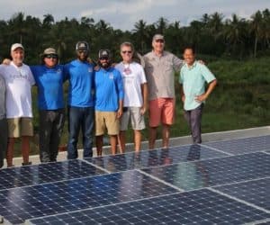 Freedom Solar's team in front of solar panels installed on roof of orphanage in Haiti