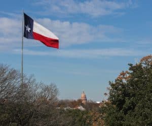 Texas flag in front of Texas State Capitol