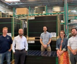 Freedom Solar's management team inside a warehouse