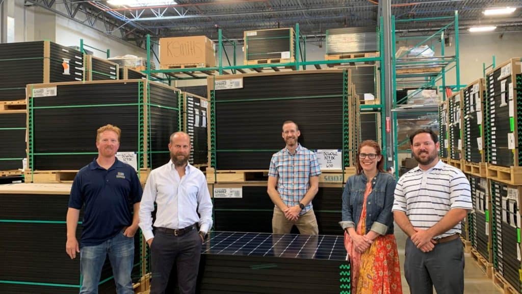 Freedom Solar's management team inside a warehouse