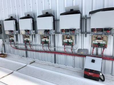 Inverters installed on wall of building, a beginner's guide to solar panels