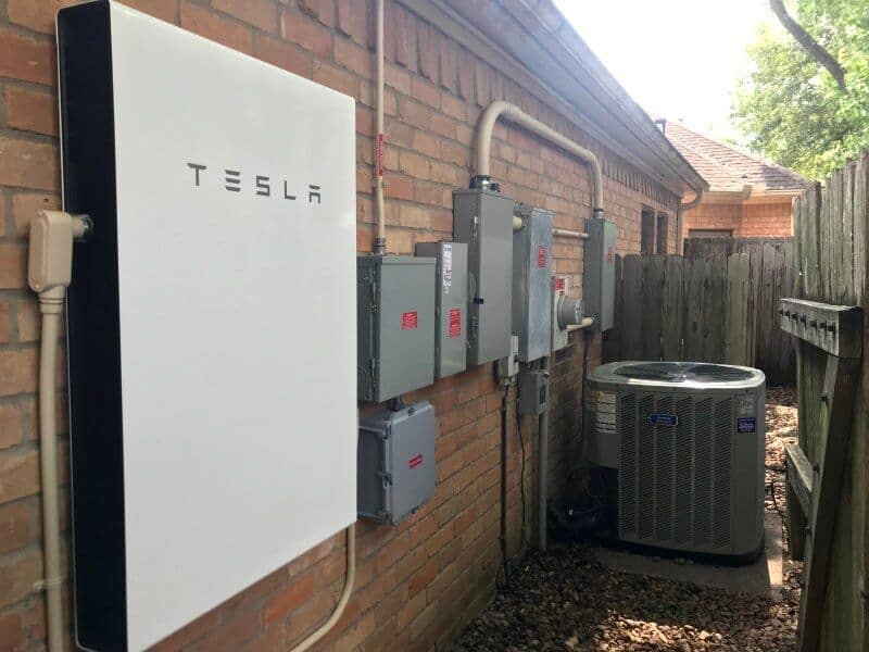 Tesla Powerwall Battery installed with electrical equipment on house wall