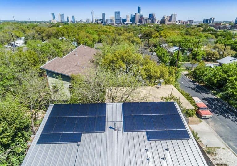 House roof on S 3rd. Street in Austin, Texas with solar panels and downtown view behind