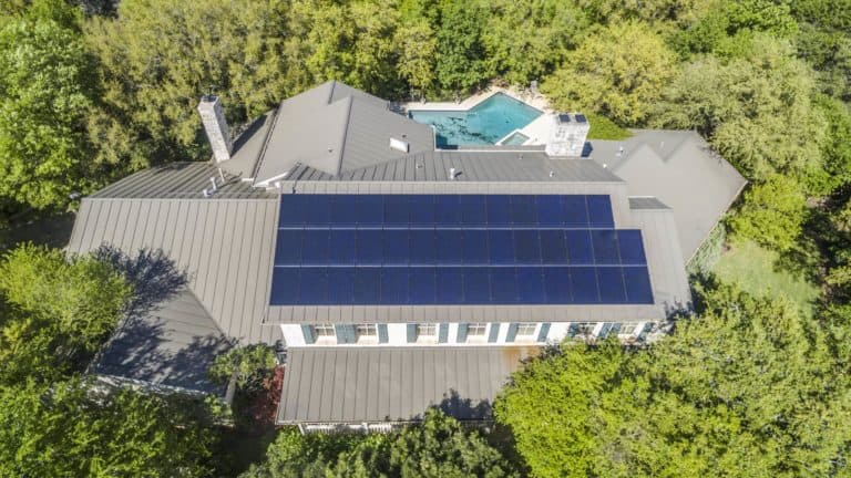 Air photo of a roof with solar panels in a house surrounded by trees in Crestwood