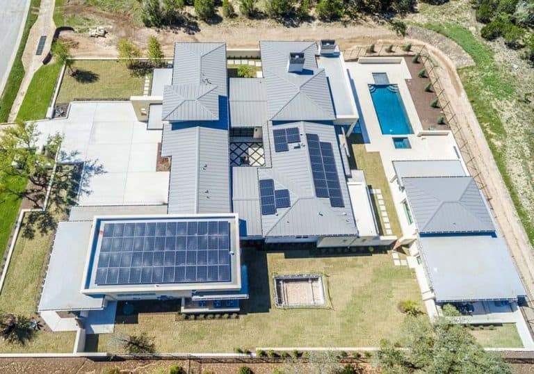 Drone view of house in Verano, Austin, Texas with solar panels installed on roof