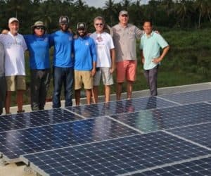 Freedom Solar's team standing next to solar panel installation in orphanage in La Montagne, Haiti