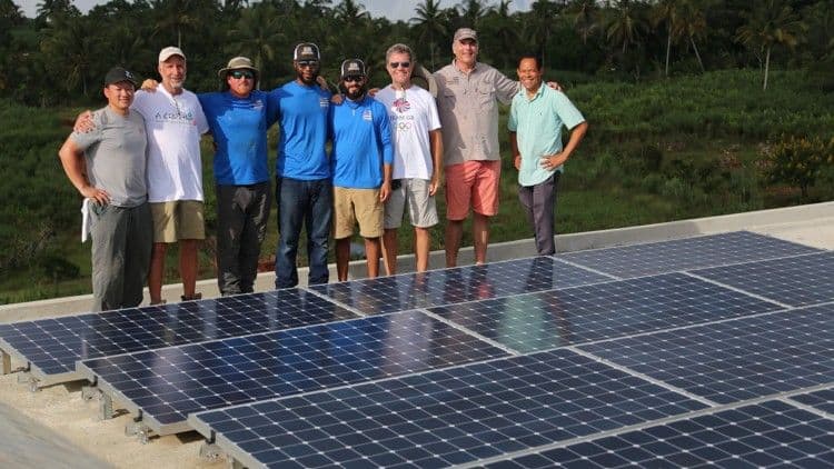 Freedom Solar's team standing next to solar panel installation in orphanage in La Montagne, Haiti