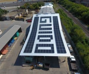 Side view of solar panels forming the word "guido" over rooftop