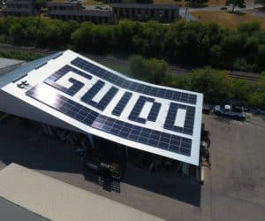 "guido" word made with solar panels on the roof of building