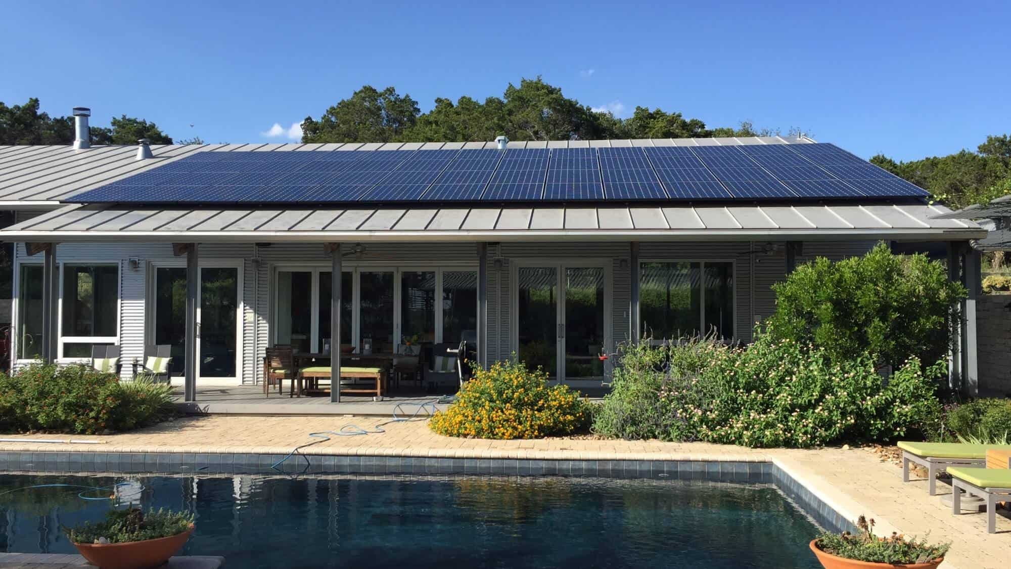 Houston house with solar panels installed on the roof and backyard view