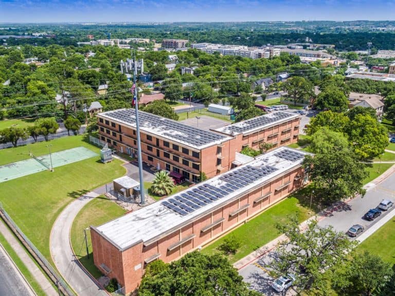 Roof of Houston-Tillotson University in Austin, Texas with solar panels installed and campus view