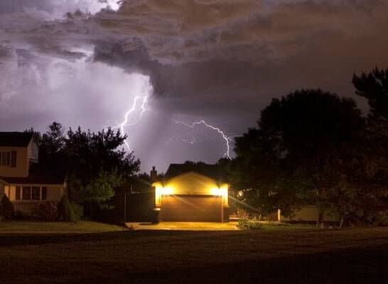 Lightning in the sky above homes