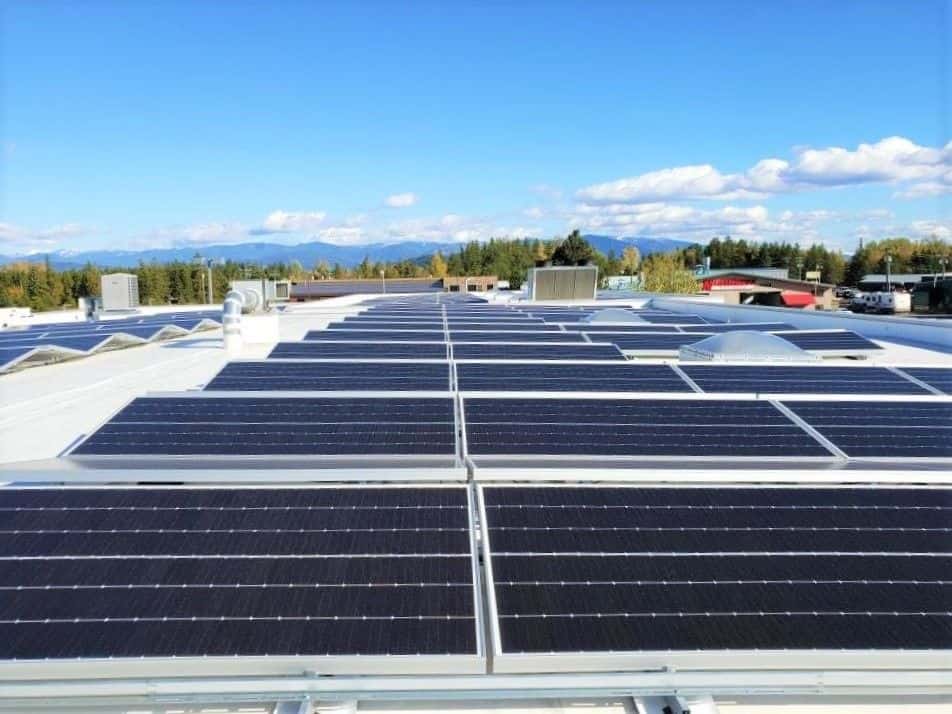Solar panels view in the roof of building with mountain view in the back