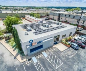 Front side aerial view of Key Staff building in San Antonio, Texas with solar panels on the roof and parked cars
