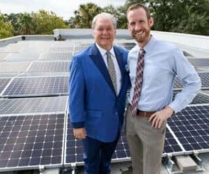 CEO of Mission Park Funeral Chapels & Cemeteries, Dick Tips and Freedom Solar's Director of Sales, Kyle Frazier on roof with solar panels installed