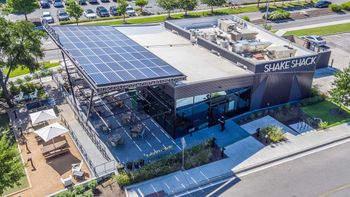 Aerial photo of solar panels on roof of a Shake Shack restaurant