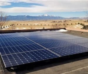 Solar panels installed on roof of a house in Peyton, Colorado and mountains in the back