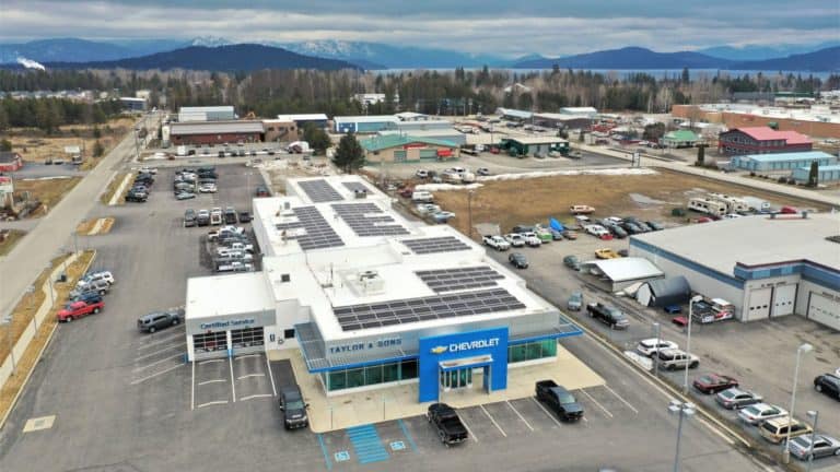 Front view of Taylor & Sons Chevrolet dealership in Ponderay, Idaho with solar panels installed on the roof