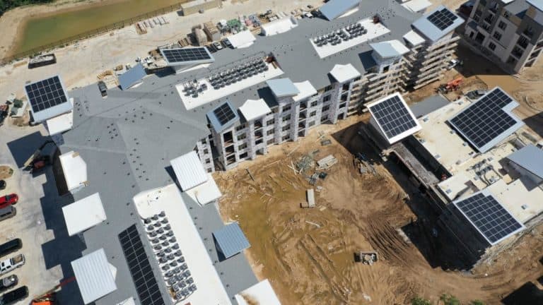 Partial aerial view of the construction of a university villa with solar panels on the roofs