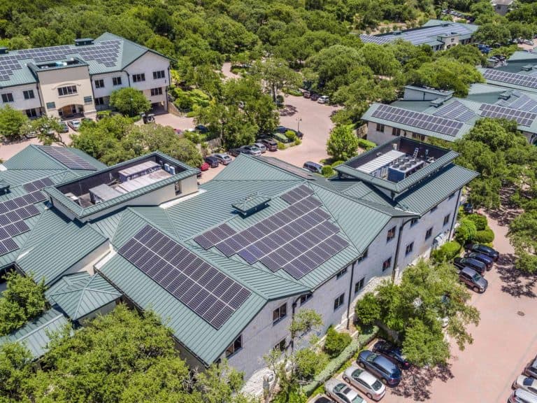 Bird's-eye view of Westlake Medical Center with solar panels installed on roof and surrounding trees