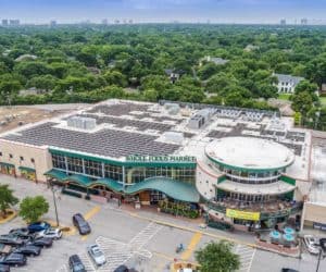 Aerial frontal view of Whole Foods Market in Dallas, Texas with array of solar panels installed on roof