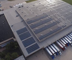 Aerial view of Brown Distributing Company roof with installed solar panels and parked trailers