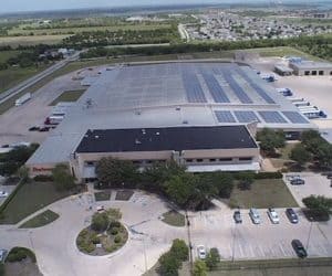 Aerial wide view of Brown Distributing Company's building in Texas with solar panels installed on the roof