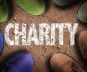 Colorful boots on the ground with the word charity