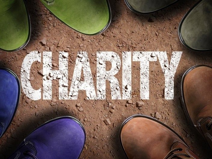 Colorful boots on the ground with the word charity