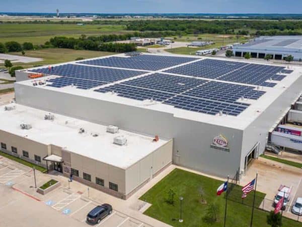 General view of Ben E. Keith Company building in Fort Worth, Texas with array of solar panels installed on the roof