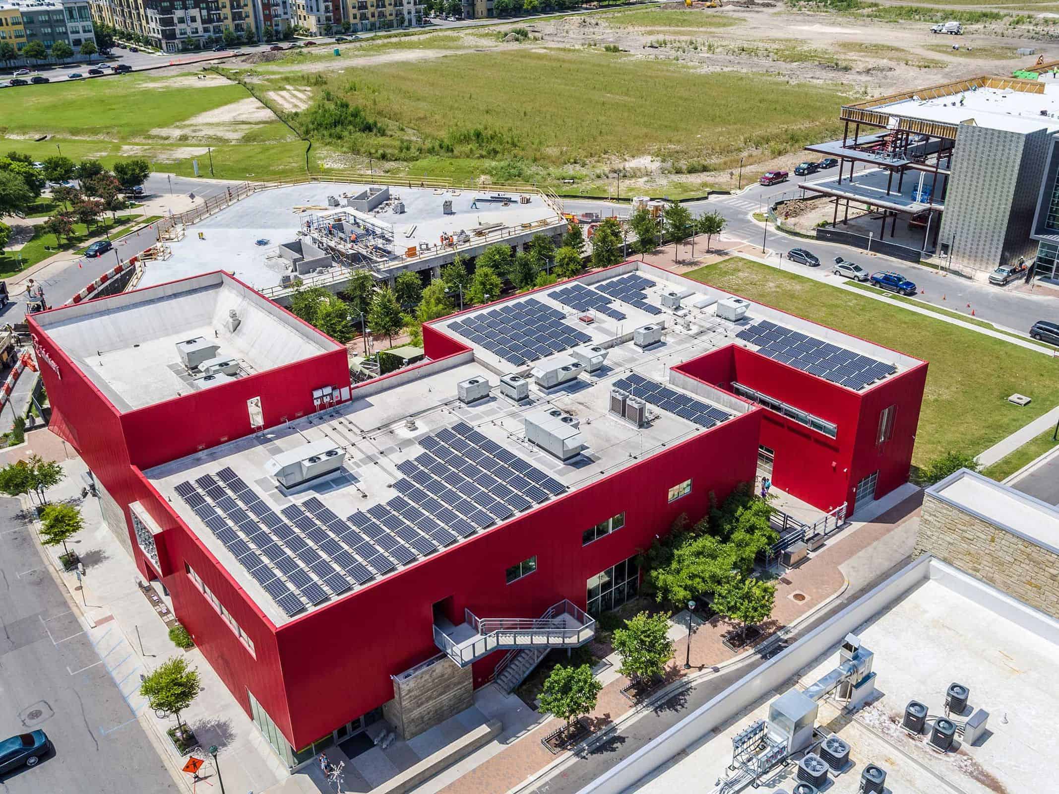Aerial photo of solar panels on a large commercial building roof