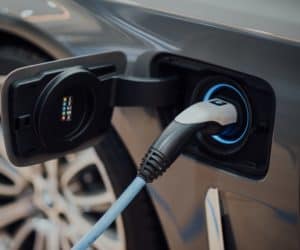 An electric vehicle with a plug-in device being used to charge