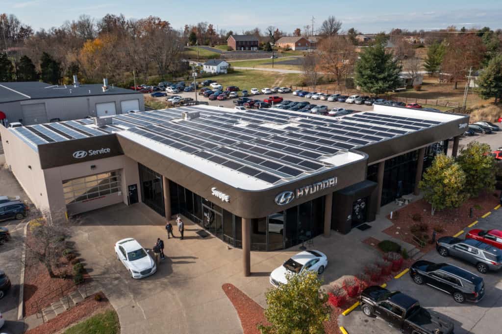 Automobile dealership with solar panels on roof