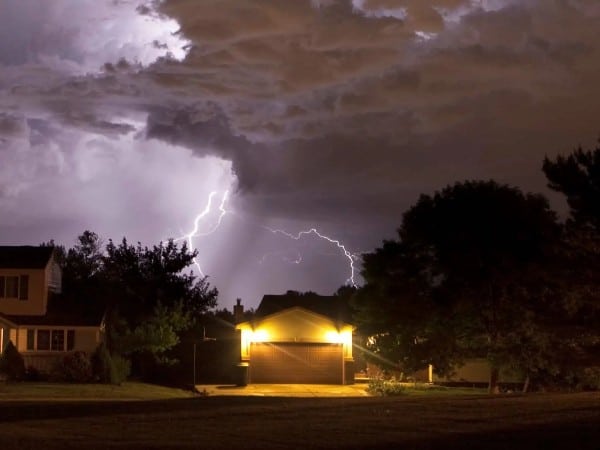 Lightning in the sky over several homes
