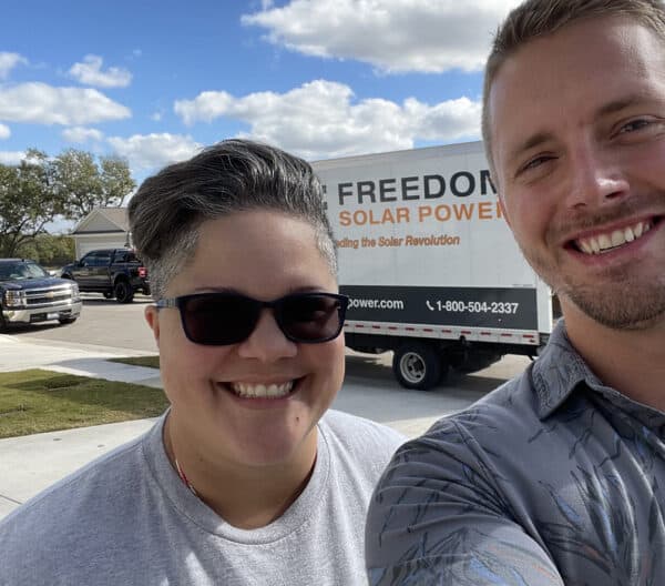 Customer in Front of Freedom Solar Truck