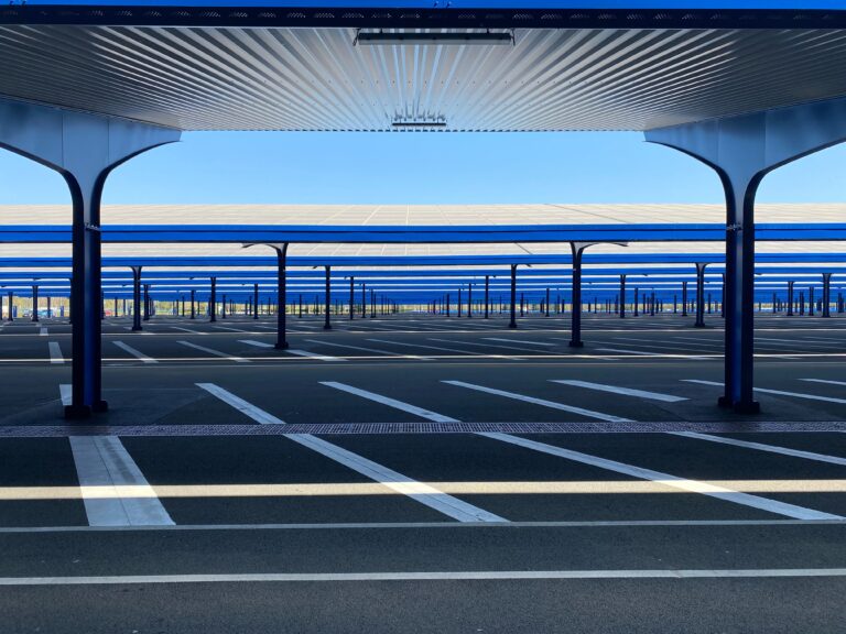 An empty parking lot shaded by solar panel carports