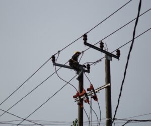 Electrical lineman working on utility pole