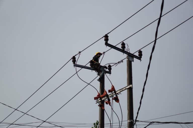 Electrical lineman working on utility pole