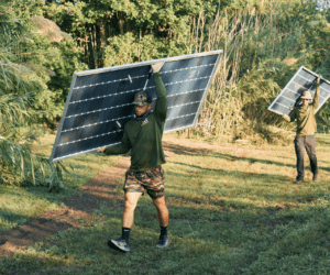 Freedom Solar installers holding panels while walking