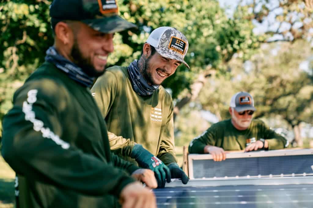 Freedom Solar Power installation crew members smiling in the sunshine