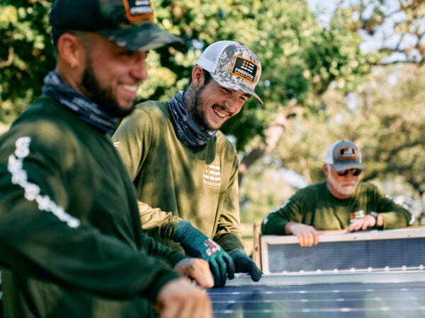 Freedom Solar Power installation crew members smiling in the sunshine