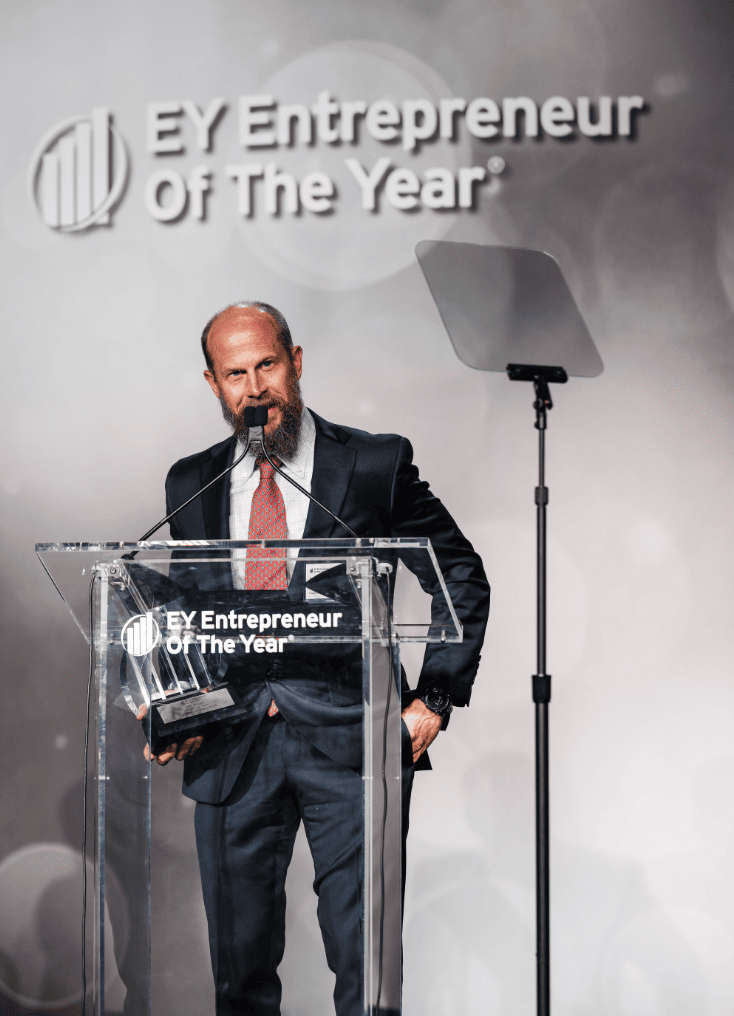 Brett Biggart, Freedom Solar's CEO, receiving Entrepreneur Of The Year® award by EY