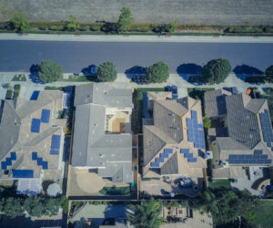Aerial view of houses with solar panels on them