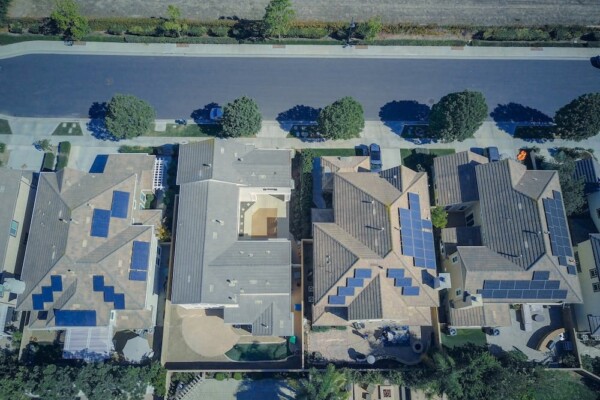 Aerial view of houses with solar panels on them
