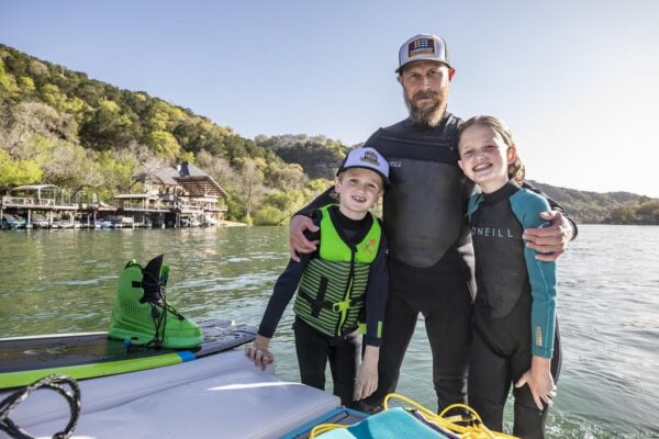 Brett Biggart and kids during day in the lake