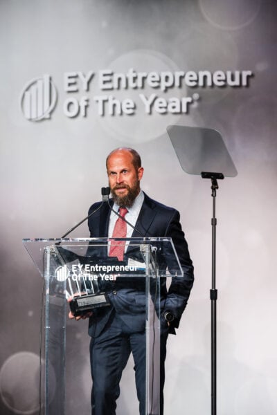 Brett Biggart, Freedom Solar's CEO, receiving Entrepreneur Of The Year® award by EY