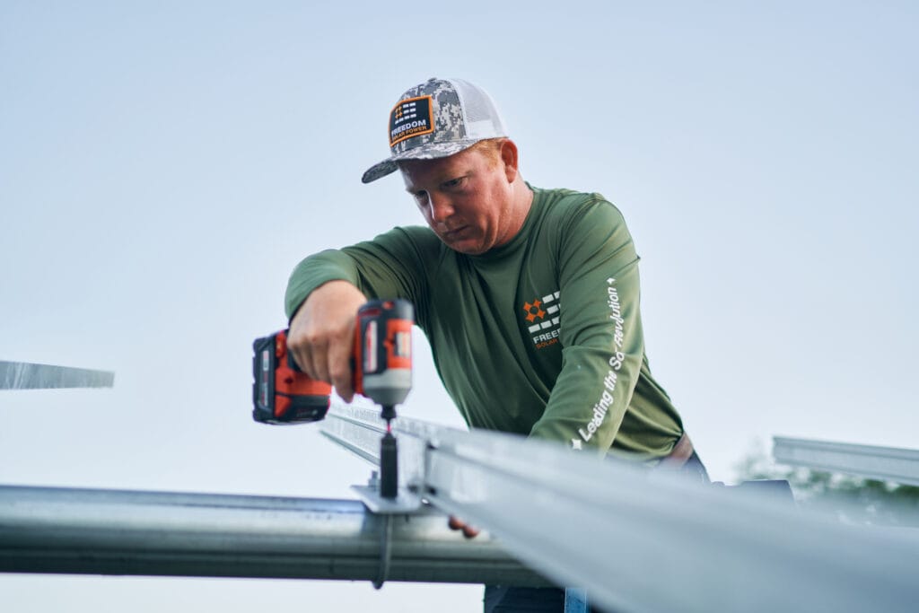 Hero shot of solar installer drilling