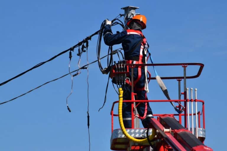 Person repairing an electrical power line.